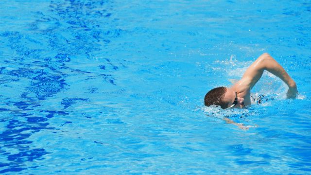 Slim sportsman swimming.