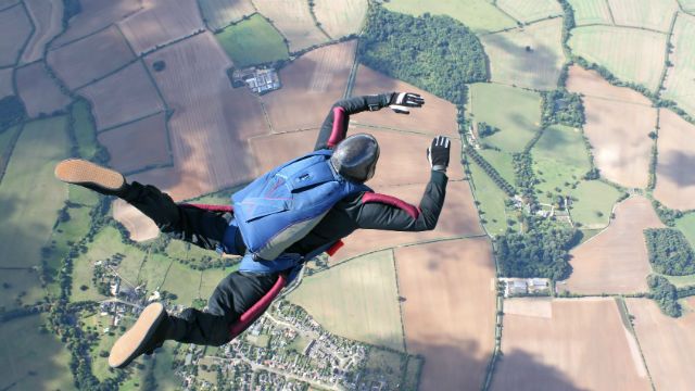 Skydiver in freefall high up in the air