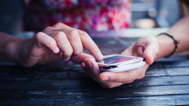 Woman using her smart phone outside