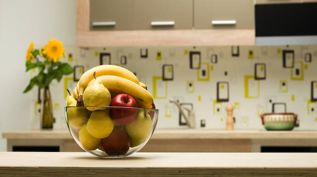bowl with healthy fruits in kitchen