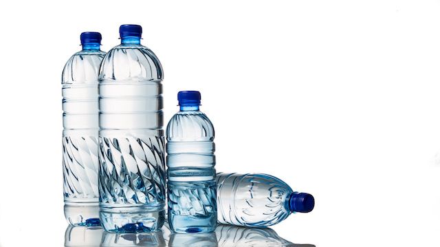 Four refreshing mineral water in plastic bottle in white background