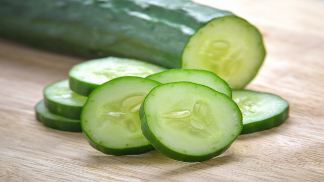 Fresh Cucumber slices on wood background