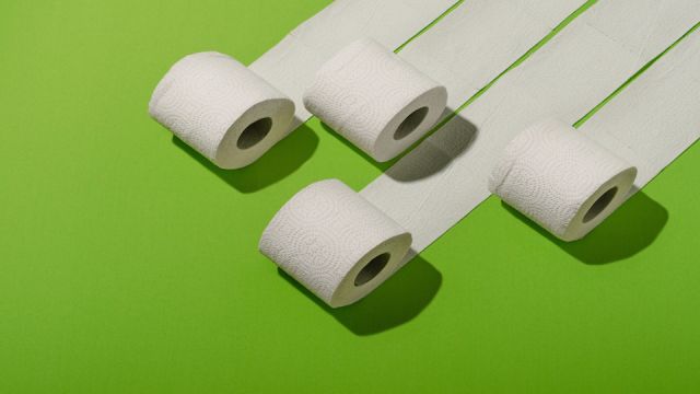 Toilet paper concept on green background. Hygiene and health. Concept photo.