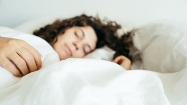 woman sleeping in bed close up blurred