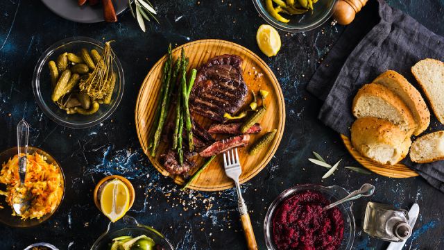BBQ Beef steak with pickled veggies, cucumber, cabbage, beeroot, marinated pepper. Dinner party.